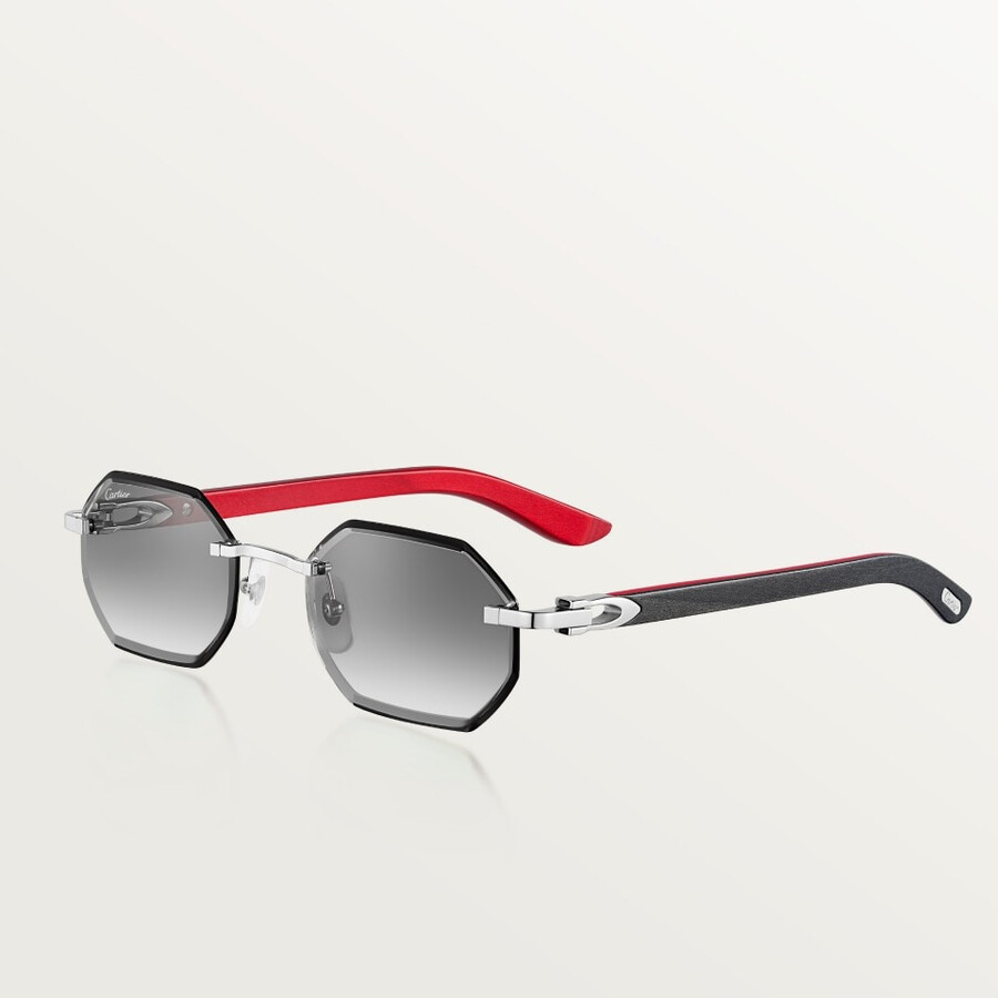 occhiali da sole cartier con design allungato a forma di c.